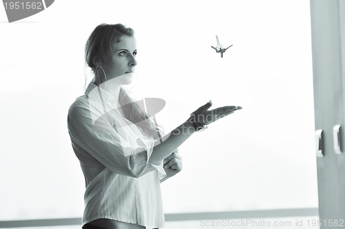 Image of young woman throwing home keys in air