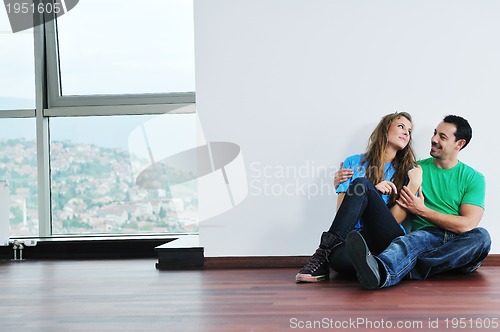 Image of happy couple in empty apartment