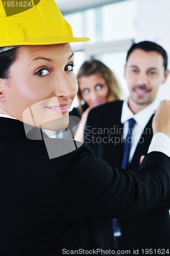 Image of happy young couple buying new home with real estate agent