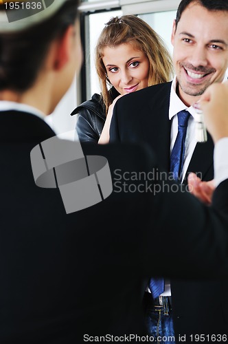 Image of happy young couple buying new home with real estate agent