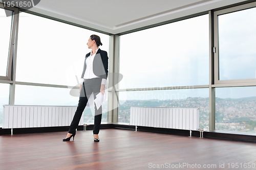 Image of young business woman throw papers in air