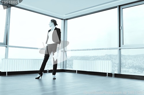 Image of young business woman throw papers in air