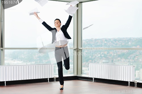 Image of young business woman throw papers in air