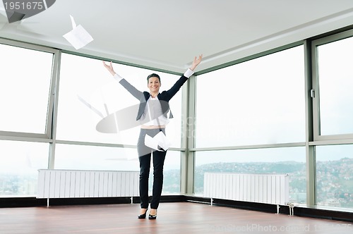 Image of young business woman throw papers in air