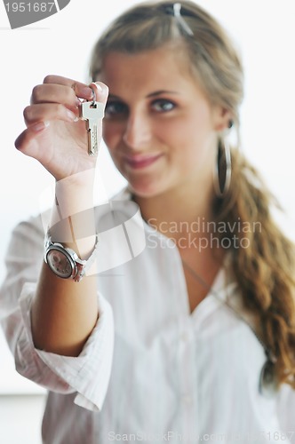 Image of young woman throwing home keys in air