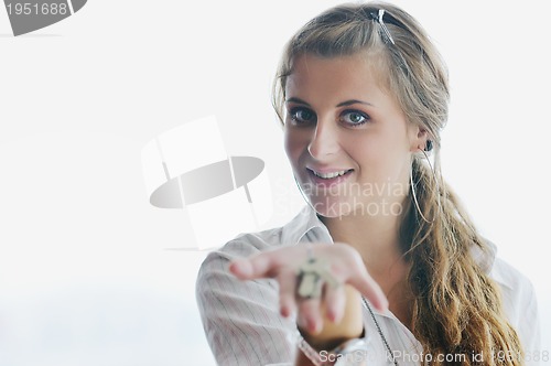 Image of young woman throwing home keys in air