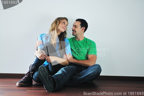 Image of happy couple in empty apartment