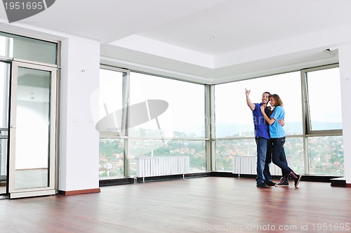 Image of happy couple in empty apartment