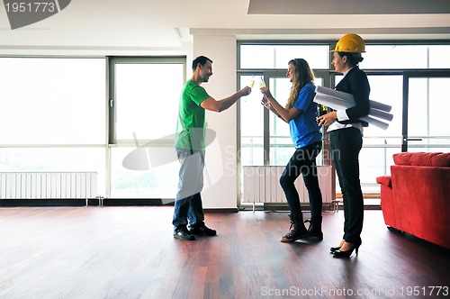 Image of happy young couple buying new home with real estate agent