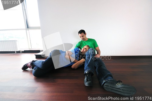 Image of happy couple have fun and work on laptop at home