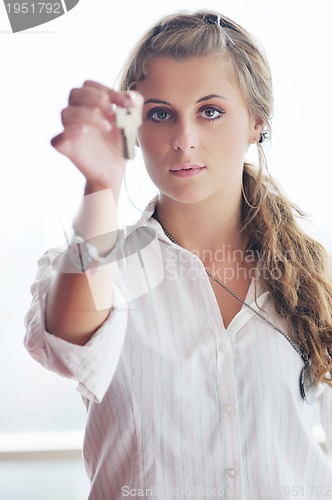 Image of young woman throwing home keys in air