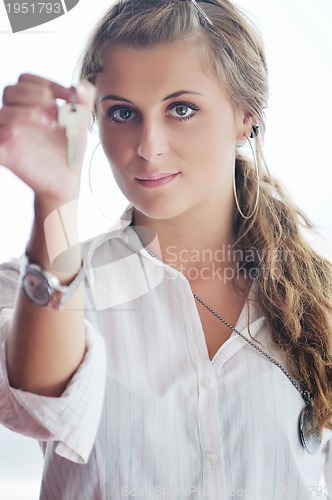 Image of young woman throwing home keys in air