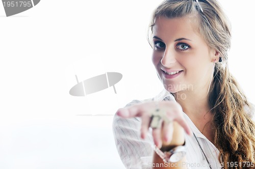 Image of young woman throwing home keys in air