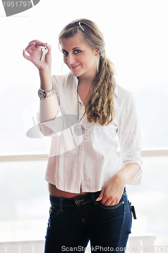 Image of young woman throwing home keys in air