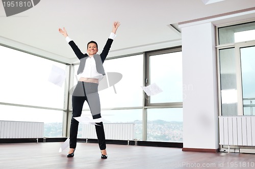 Image of young business woman throw papers in air