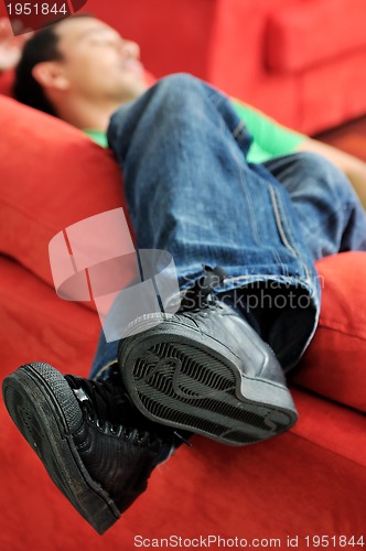 Image of man relaxing on sofa