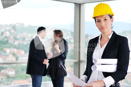 Image of happy young couple buying new home with real estate agent