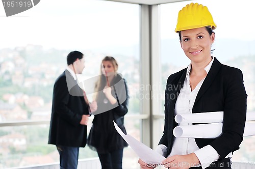 Image of happy young couple buying new home with real estate agent