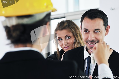 Image of happy young couple buying new home with real estate agent