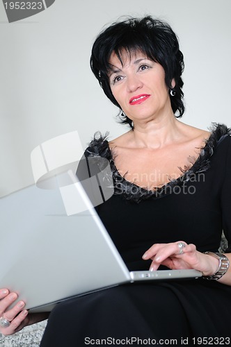 Image of senior woman work on laptop