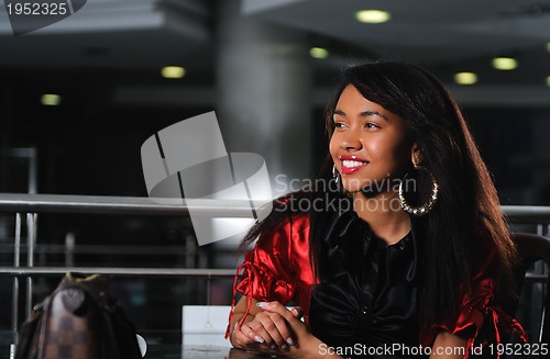 Image of business woman in red dress smilling