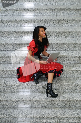 Image of business woman with laptop on staircase