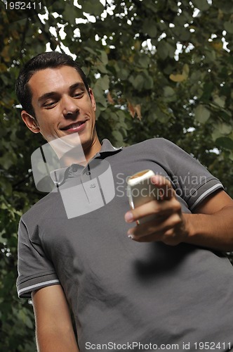 Image of young casual man talking on cellphone