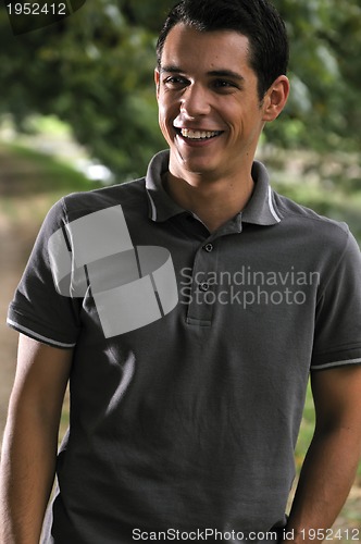 Image of  young casual man outdoor portrait smiling