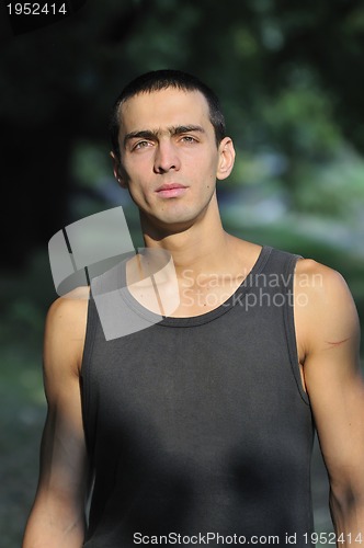 Image of  young casual man outdoor portrait smiling