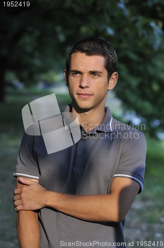 Image of  young casual man outdoor portrait smiling