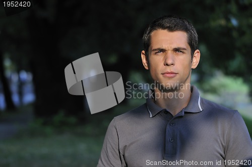 Image of  young casual man outdoor portrait smiling