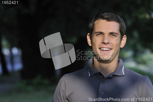 Image of  young casual man outdoor portrait smiling