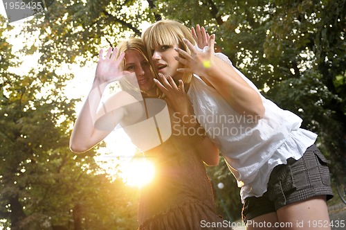 Image of two girls together outside in dancing position ready for party