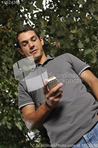 Image of young casual man talking on cellphone