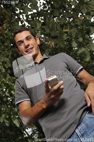 Image of young casual man talking on cellphone