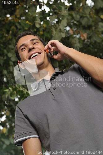 Image of young casual man talking on cellphone