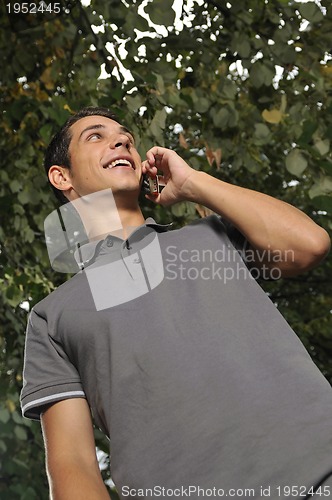 Image of young casual man talking on cellphone