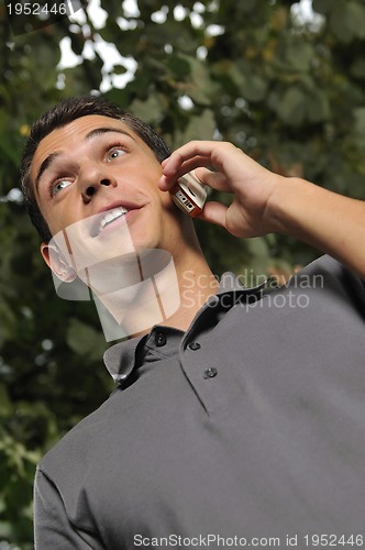 Image of young casual man talking on cellphone