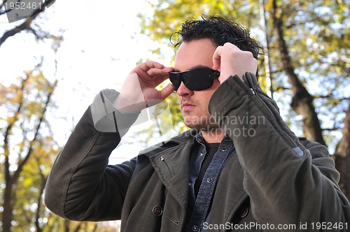 Image of happy young casual man outdoor portrait posing