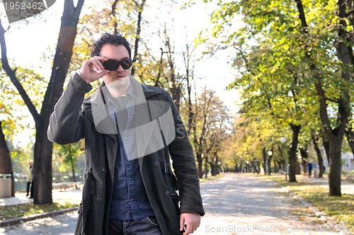 Image of happy young casual man outdoor portrait posing