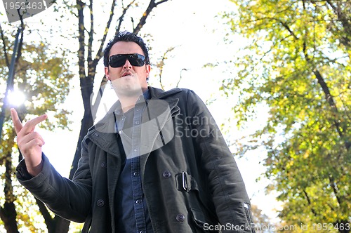 Image of happy young casual man outdoor portrait posing