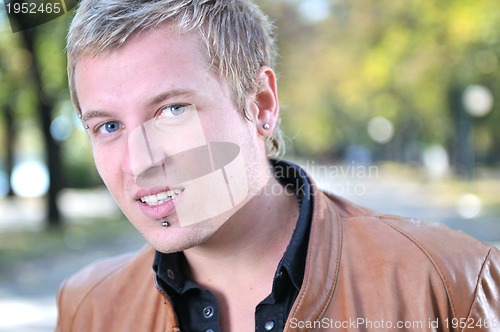 Image of happy young casual man outdoor portrait smiling