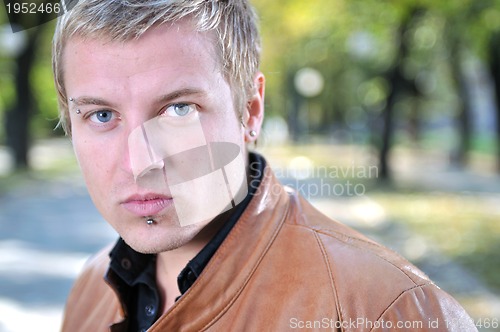 Image of happy young casual man outdoor portrait posing