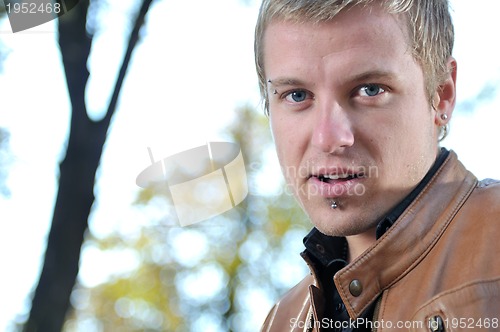 Image of happy young casual man outdoor portrait posing