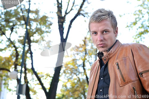 Image of happy young casual man outdoor portrait posing