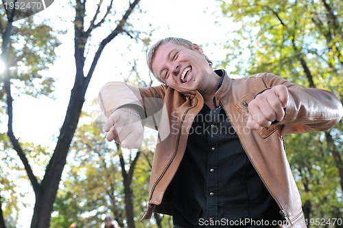 Image of Handsome young man expressing his inner feeling outside in natur