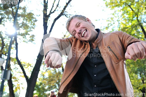 Image of happy young casual man outdoor portrait posing