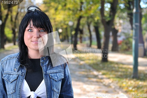 Image of brunette Cute young woman posing outdoors