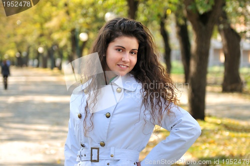 Image of brunette Cute young woman smiling outdoors in nature