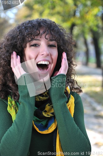 Image of Young curly woman screeming 